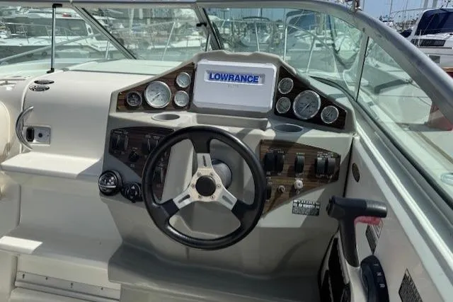 Slide: The Image of Cockpit of 2010 Bayliner 255 Cruiser with steering wheel and navigation instruments. - 29