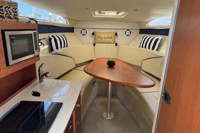 Slide: The Image of Interior of 2010 Bayliner 255 Cruiser with cozy seating and kitchenette. - 32