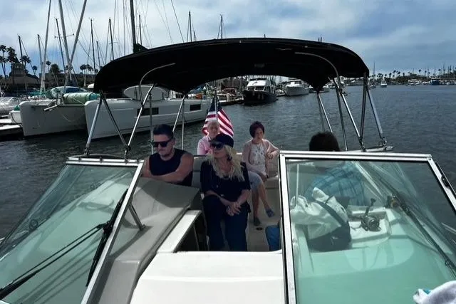 Slide: The Image of 2010 Bayliner 255 Cruiser with passengers in a marina setting. - 47