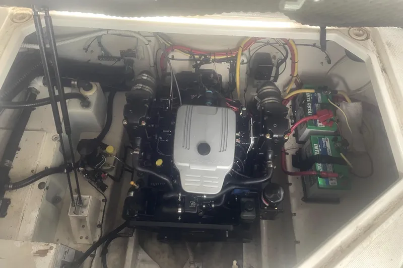 Slide: The Image of Engine compartment of a 2010 Bayliner 255 Cruiser with visible batteries and wiring. - 55