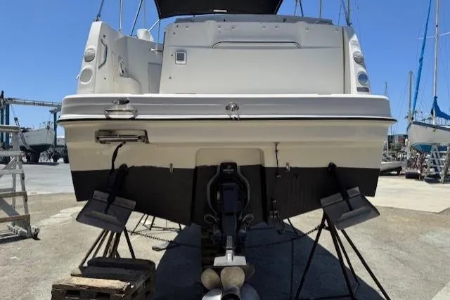 Slide: The Image of 2010 Bayliner 255 Cruiser boat on stands in a marina, rear view. - 7