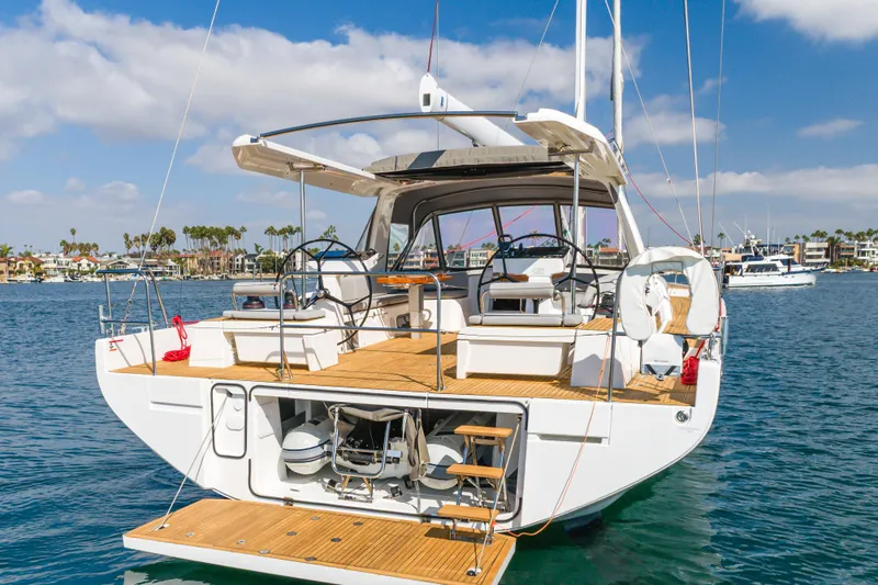 Slide: The Image of 2023 Beneteau Oceanis Yacht 60, elegant design, docked in a sunny marina. - 15
