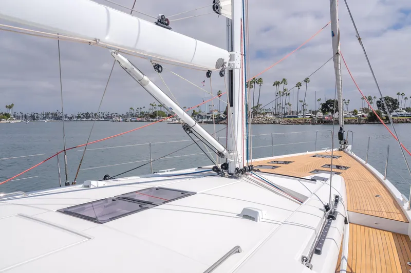Slide: The Image of 2023 Beneteau Oceanis Yacht 60 sailing on calm waters with clear skies. - 16
