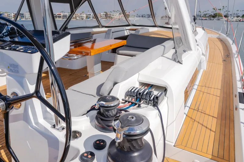 Slide: The Image of 2023 Beneteau Oceanis Yacht 60 cockpit with steering wheel and seating area. - 17