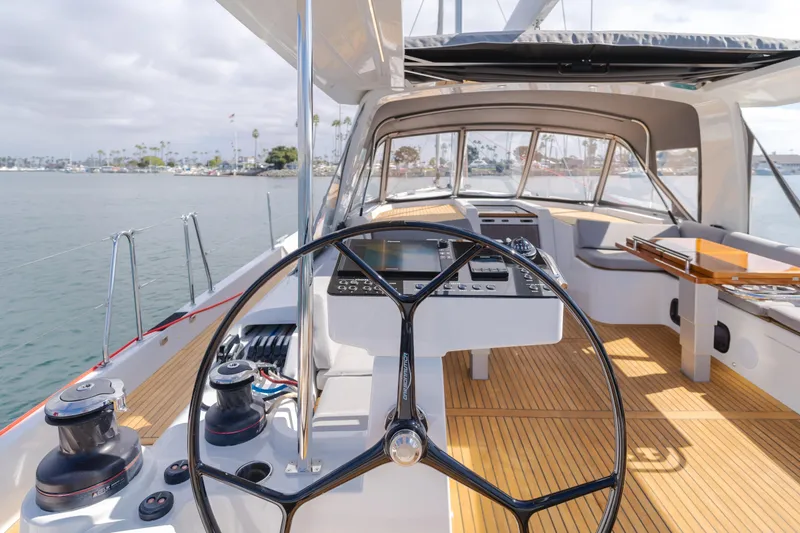 Slide: The Image of 2023 Beneteau Oceanis Yacht 60 cockpit with modern steering and navigation system. - 19