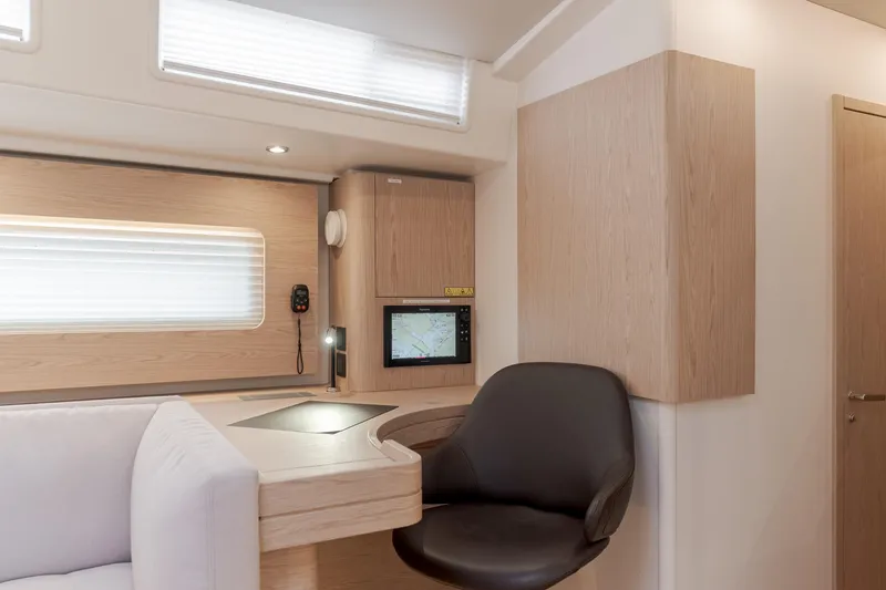 Slide: The Image of Modern interior of 2023 Beneteau Oceanis Yacht 60 with navigation station and seating. - 30