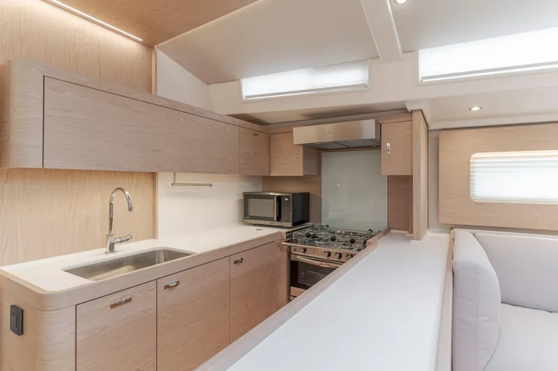 Slide: The Image of Modern kitchen interior of 2023 Beneteau Oceanis Yacht 60 with sleek cabinetry and appliances. - 32