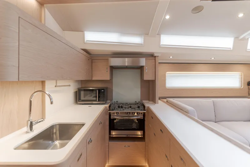 Slide: The Image of Modern kitchen interior of 2023 Beneteau Oceanis Yacht 60, featuring sleek cabinetry and appliances. - 33