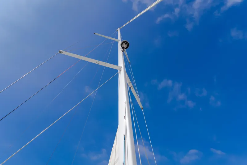 Slide: The Image of Mast of 2023 Beneteau Oceanis Yacht 60 against a clear blue sky. - 48