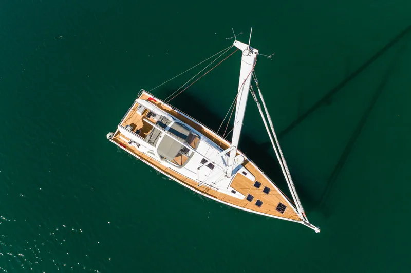 Slide: The Image of Aerial view of 2023 Beneteau Oceanis Yacht 60 sailing on calm waters. - 9