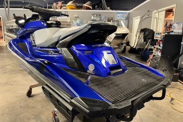 Slide: The Image of 2014 Yamaha WaveRunner FX Cruiser HO in a showroom, blue and black design. - 7