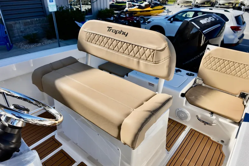 Slide: The Image of 2026 Bayliner Trophy T22CC boat interior with tan seating and steering wheel. - 11