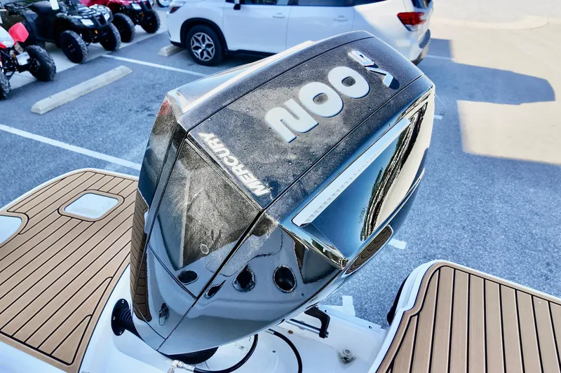 Slide: The Image of 2026 Bayliner Trophy T22CC with Mercury outboard engine in parking lot. - 6