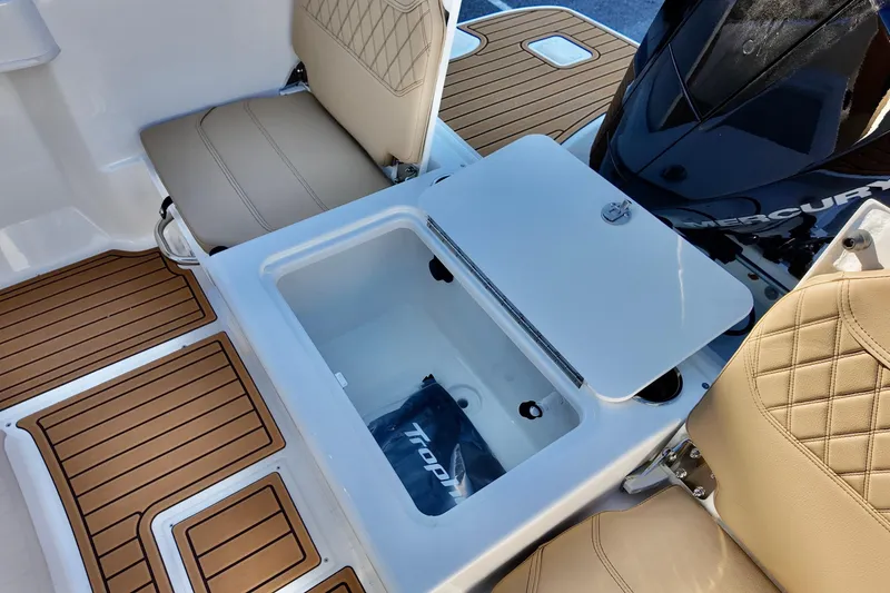 Slide: The Image of 2026 Bayliner Trophy T22CC boat interior with storage compartment and cushioned seating. - 7