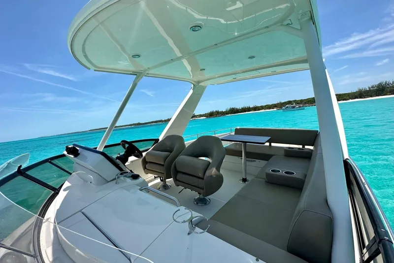 Slide: The Image of 2017 Carver C40 yacht interior with seating, table, and ocean view. - 4