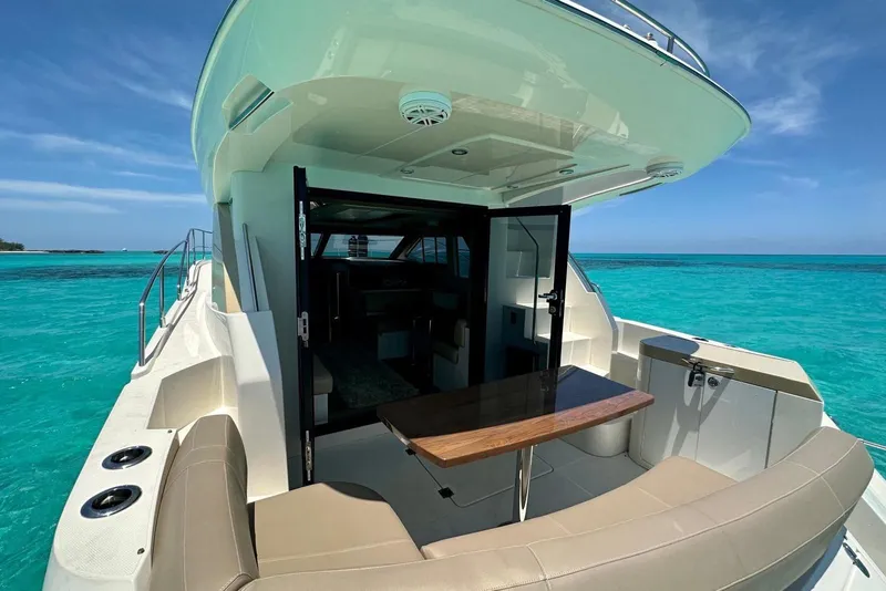 Slide: The Image of 2017 Carver C40 yacht with open deck, turquoise sea, and clear sky. - 8
