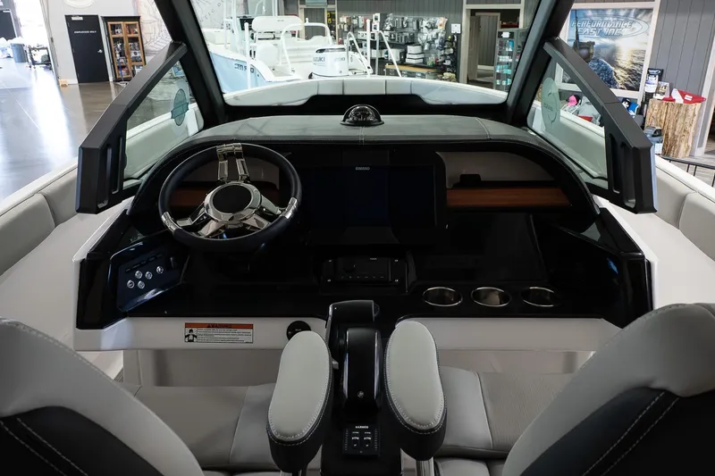Slide: The Image of Interior cockpit of 2026 Monterey Elite 25 OB boat, featuring modern steering and controls. - 10