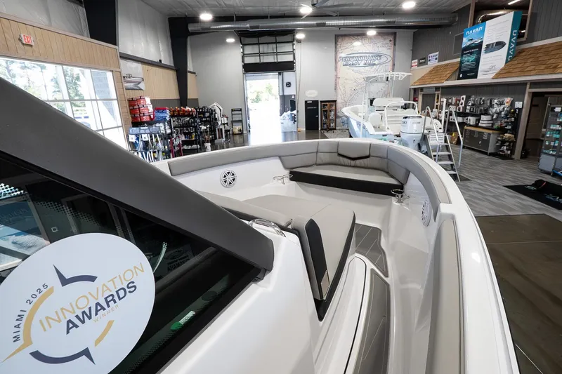 Slide: The Image of 2026 Monterey Elite 25 OB boat displayed in showroom, featuring Miami 2025 Innovation Awards sticker. - 12