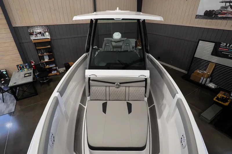 Slide: The Image of 2026 Monterey Elite 25 OB boat interior with sleek seating and modern design. - 14
