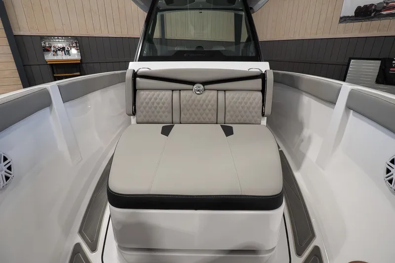 Slide: The Image of 2026 Monterey Elite 25 OB boat interior with cushioned seating and modern design. - 15