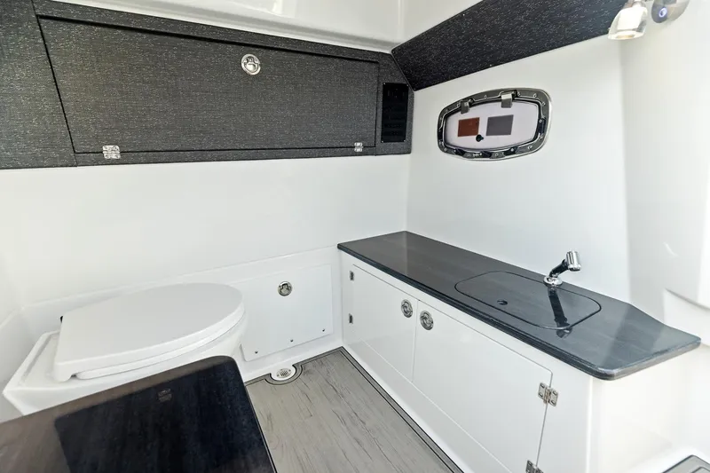 Slide: The Image of Manufacturer Provided Image: 2026 Monterey Elite 25 OB boat interior with modern bathroom and sleek design. - 5