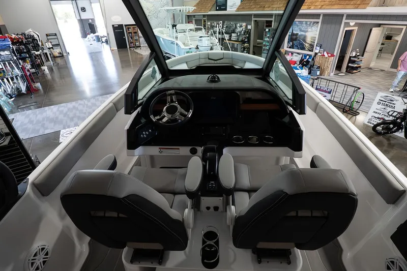 Slide: The Image of Interior view of 2026 Monterey Elite 25 OB boat in showroom setting. - 9