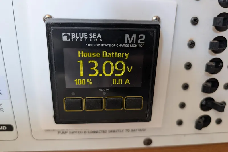 Slide: The Image of Blue Sea Systems battery monitor displaying 13.09 volts, 100% charge on Catalina 310, 2004 model. - 21