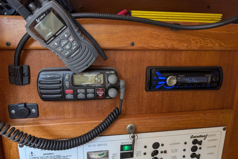 Slide: The Image of 2004 Catalina 310 yacht interior with radio and control panel. - 22