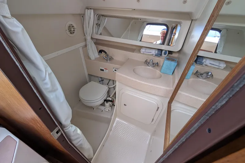 Slide: The Image of 2004 Catalina 310 yacht bathroom with shower, sink, and mirror. - 23