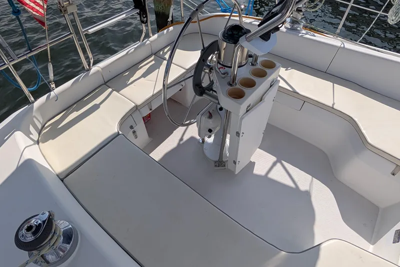 Slide: The Image of Cockpit of a 2004 Catalina 310 sailboat with steering wheel and seating. - 26