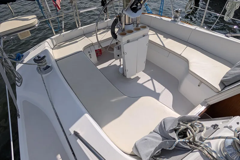 Slide: The Image of Cockpit of a 2004 Catalina 310 sailboat with seating and steering wheel. - 27