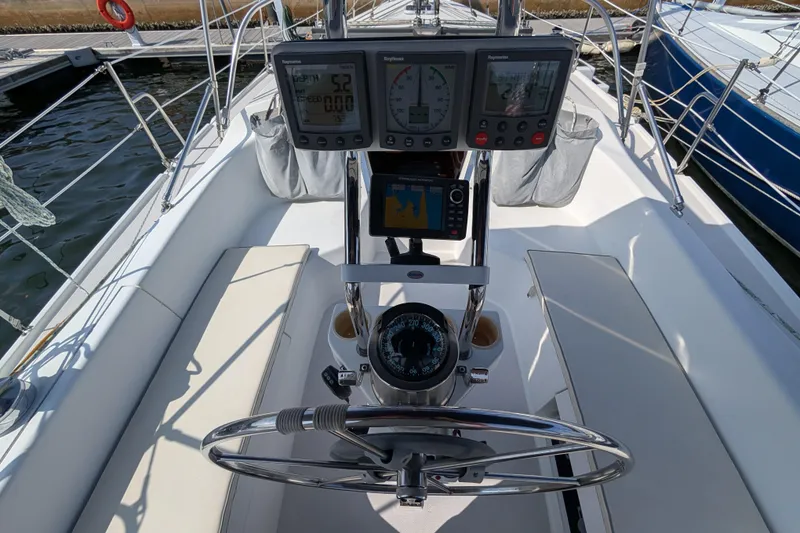 Slide: The Image of Cockpit of 2004 Catalina 310 sailboat with navigation instruments and steering wheel. - 30
