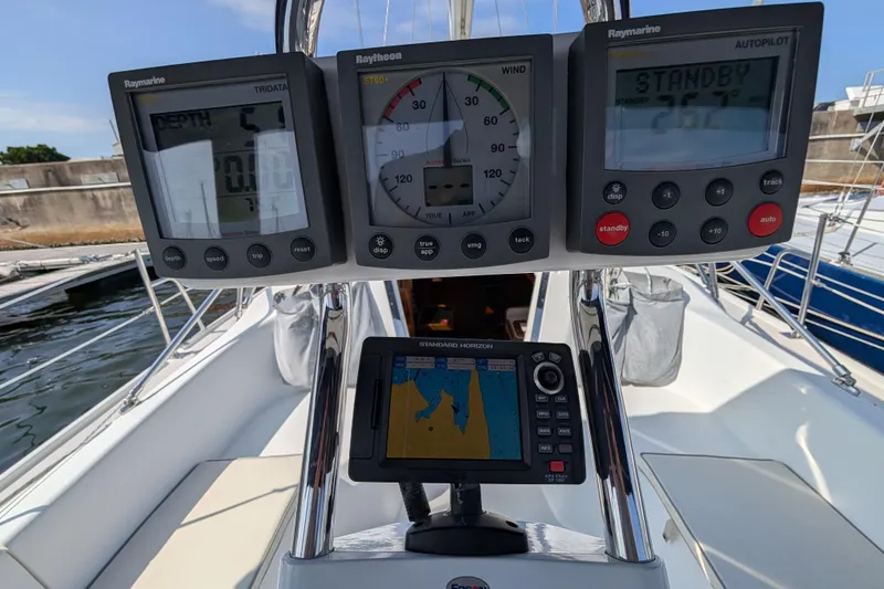 Slide: The Image of Cockpit instruments on a 2004 Catalina 310 sailboat, featuring navigation and autopilot displays. - 31