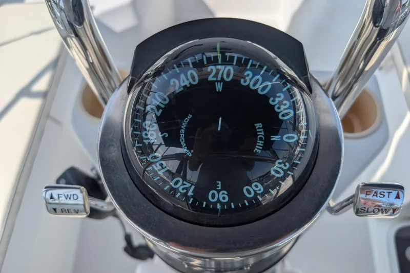 Slide: The Image of Compass and controls on a 2004 Catalina 310 sailboat. - 34