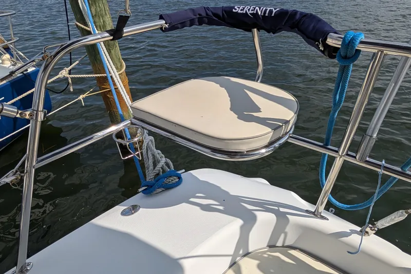Slide: The Image of 2004 Catalina 310 sailboat stern with stainless steel rail and blue ropes. - 35