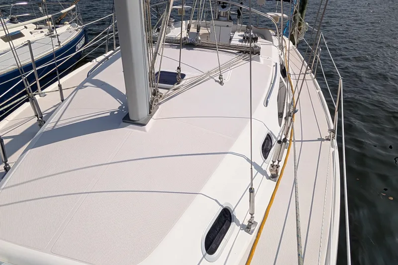 Slide: The Image of 2004 Catalina 310 sailboat deck view, docked on calm water. - 38