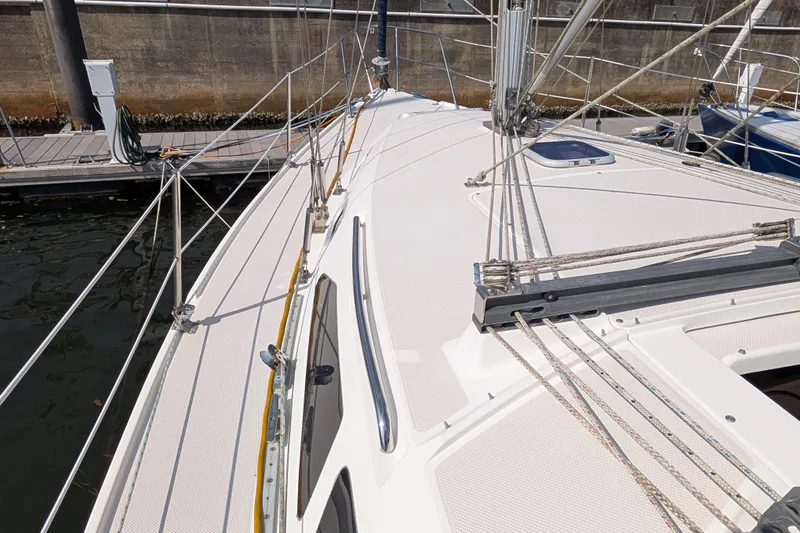 Slide: The Image of 2004 Catalina 310 sailboat deck with rigging, docked at marina. - 40