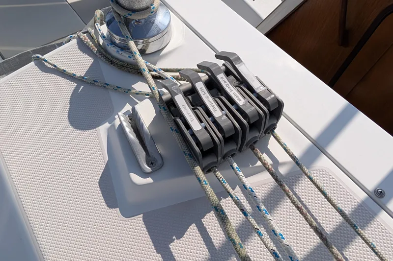 Slide: The Image of Deck of 2004 Catalina 310 sailboat with rope clutches and winch. - 43