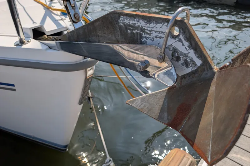 Slide: The Image of Catalina 310 sailboat anchor detail, 2004 model, docked on calm water. - 46