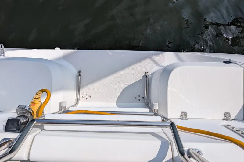 Slide: The Image of 2004 Catalina 310 boat deck with ladder and power cables by the water. - 48