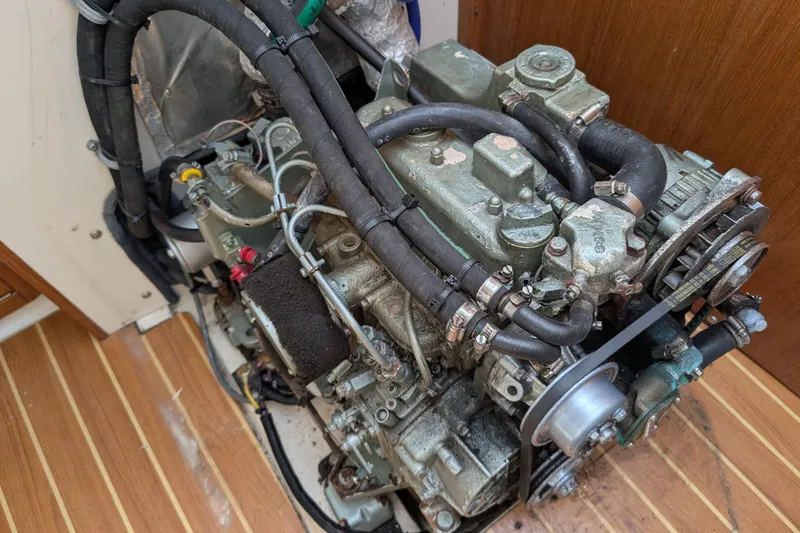 Slide: The Image of Engine of a 2004 Catalina 310 sailboat, showcasing detailed mechanical components. - 55
