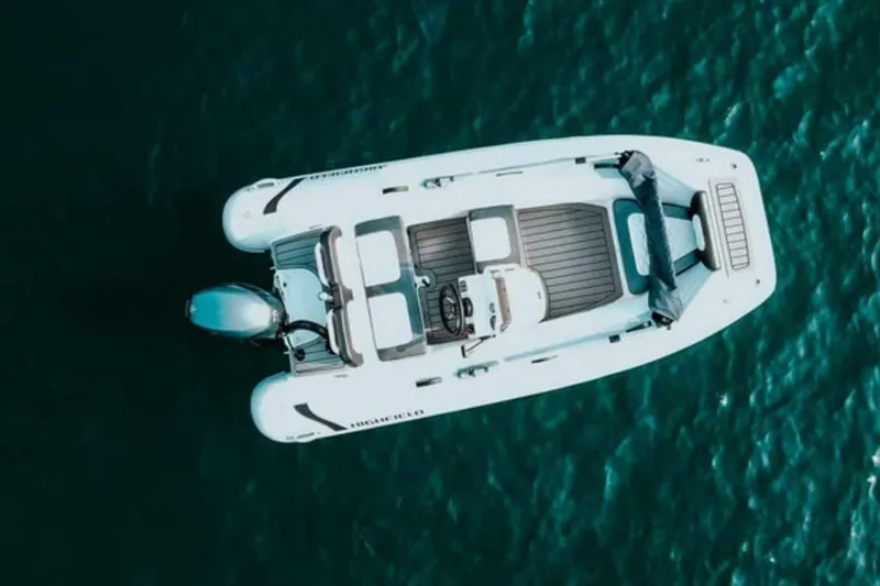 Slide: The Image of Aerial view of 2023 Highfield Sport 360 boat on blue water. - 2