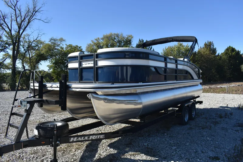 Slide: The Image of 2026 Lowe SS 230 DV pontoon boat on trailer, parked outdoors. - 4