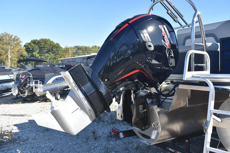 Slide: The Image of 2026 Lowe SS 230 DV boat with powerful outboard motor in a marina setting. - 6