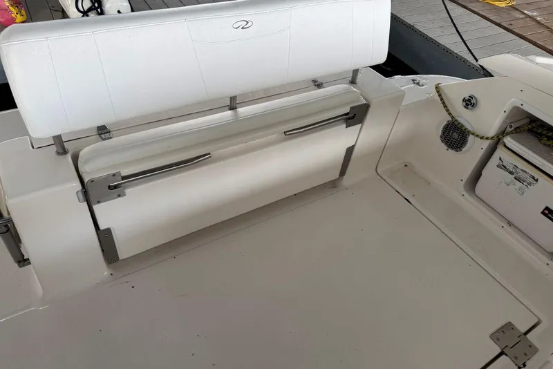 Slide: The Image of 2005 Regal 3360 Window Express boat interior with white seating and storage compartment. - 13