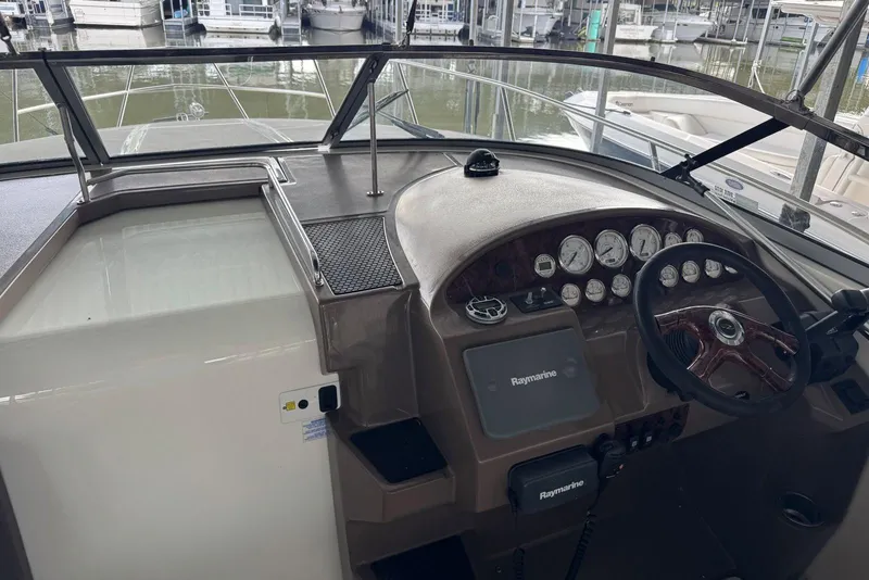 Slide: The Image of 2005 Regal 3360 Window Express boat helm with Raymarine navigation system and gauges. - 16
