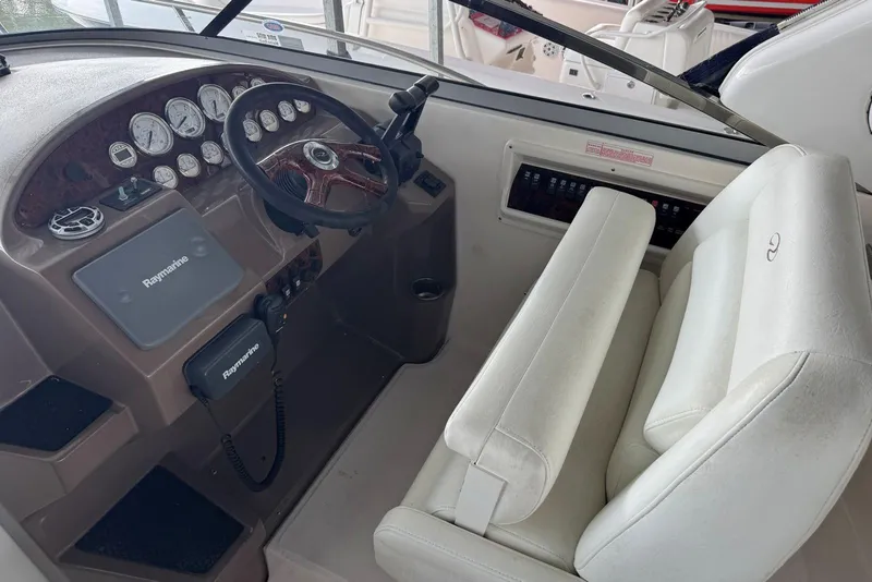 Slide: The Image of 2005 Regal 3360 Window Express helm with Raymarine electronics and white seating. - 17