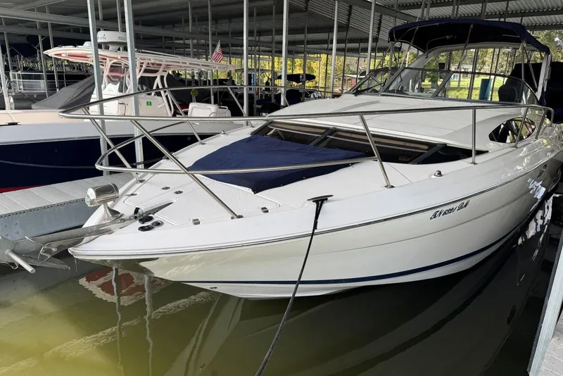 Slide: The Image of 2005 Regal 3360 Window Express boat docked in marina under covered shelter. - 2