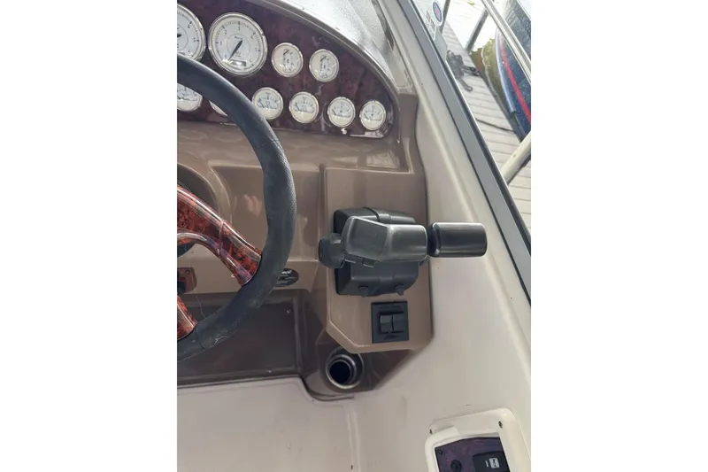 Slide: The Image of 2005 Regal 3360 Window Express dashboard with steering wheel and control panel. - 21