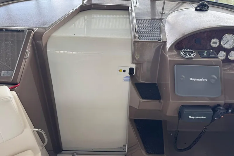 Slide: The Image of 2005 Regal 3360 Window Express boat dashboard with Raymarine equipment. - 22